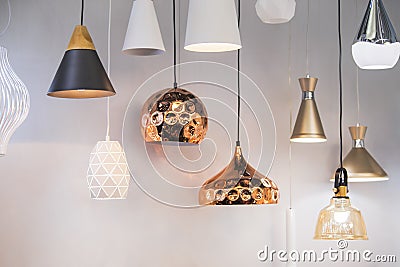 Different modern streamlined mirror copper chandeliers. Bubble metal copper shade pendant Stock Photo