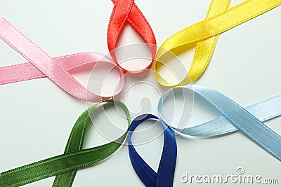 Different multi colored awareness ribbons on white background Stock Photo