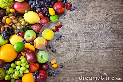 Different Organic Fruits with water drops on wooden table back Stock Photo