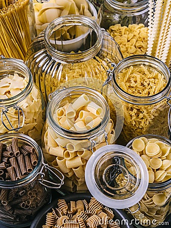 Different pasta in large jars Stock Photo