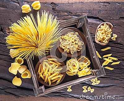 Different pasta types on the wooden table. Top view Stock Photo