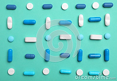 Different pills and capsules on color background Stock Photo