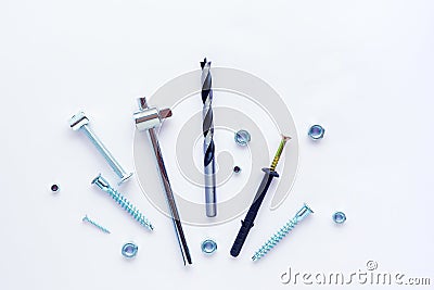 Different screws, bolts, nuts, drill, tools on a white background Stock Photo