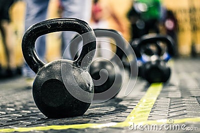 Different sizes of kettlebells weights lying on gym floor. Stock Photo