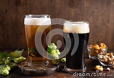 different sorts of craft beer in frosty glasses and snacks on table Stock Photo