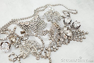 Different sparkling fake diamond jewelery The concept of luxury life, wealth, glamor, fashion and weddings Stock Photo