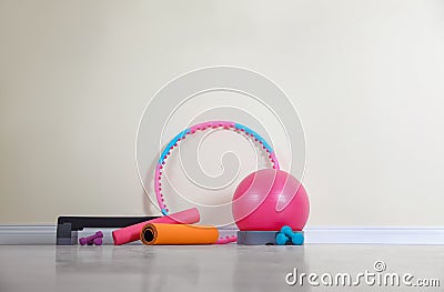 Different sports equipment near wall in gym Stock Photo