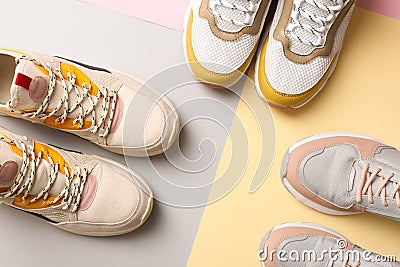 Different sports shoes on color background Stock Photo