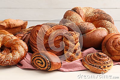 Different tasty freshly baked pastries on white table Stock Photo