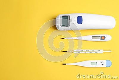 Different thermometers on background, flat lay. Space for text Stock Photo