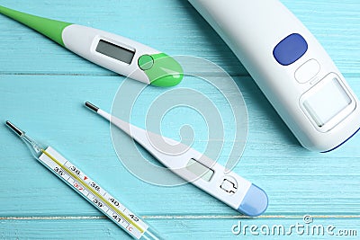 Different thermometers on blue wooden table, flat lay Stock Photo