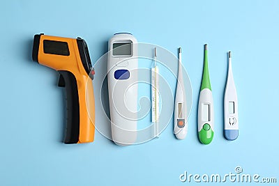 Different thermometers on blue background, flat lay Stock Photo