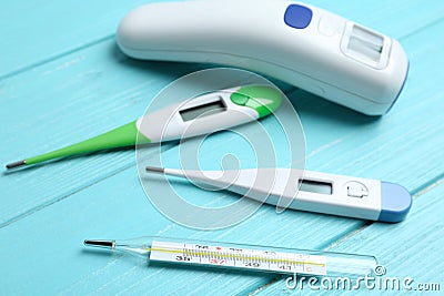 Different thermometers on blue wooden table Stock Photo