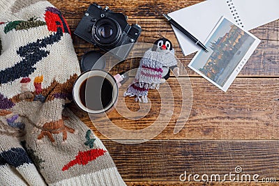 Different things for travel on a wooden background. Soviet retro camera and postcard Czech Republic and a cup of coffee. Editorial Stock Photo