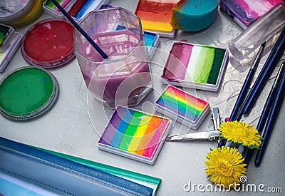 Different tools and paints for Aqua makeup and body art are on the table Stock Photo