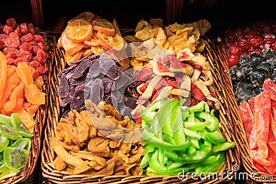 Different types of caramelized and dried fruits on a tray in the Boqueria market Stock Photo