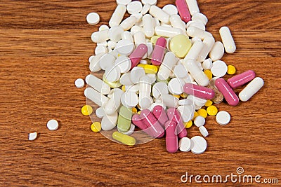 Different types of drugs are scattered on the table. Treatment of diseases with modern methods. Homeopathic and chemicals. Stock Photo