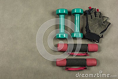 Different types of dumbbells and fingerless gloves. Stock Photo