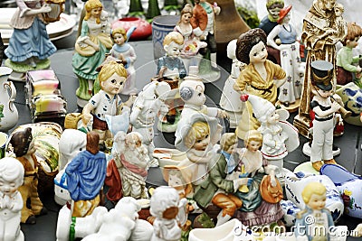 Ceramic statuettes for sale in the flea market. Editorial Stock Photo