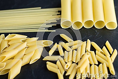 Different types of pasta penne pennoni cannelloni noodles Stock Photo