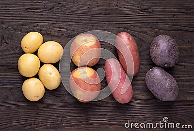 Different types of potatoes on dark wooden rustic table Stock Photo