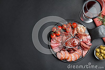 Different types of sausages with sauce served on black background, flat lay. Space for text Stock Photo