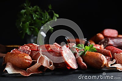 Different types of sausages served on black table. Space for text Stock Photo