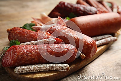 Different types of sausages served on wooden table, closeup Stock Photo