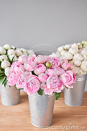Different varieties of peonies in a metal vases. Beautiful peony flower for catalog or online store. Floral shop concept Stock Photo