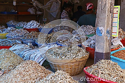 Different variety of dry fishes stored in a basket for sell in a market stall Stock Photo