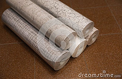 Different wall paper rolls on floor indoors Stock Photo