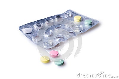 Differently colored pills for morning, afternoon and evening Stock Photo