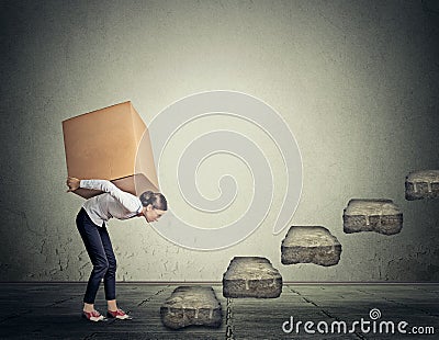 Difficult task concept. Woman carrying heavy box upstairs Stock Photo