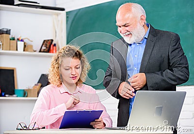 Difficult tasks. Final test and graduation. Lecturer educator helping student with test. Pass exam. Knowledge test. High Stock Photo