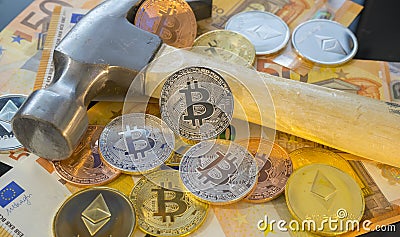 Dig Bitcoin mining or mine for bitcoin, compared to the traditional idea of physical mining with a pickaxe Stock Photo