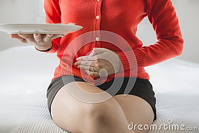 Digestion problems,Woman with stomach pain after eating,Hand female holding her belly Stock Photo