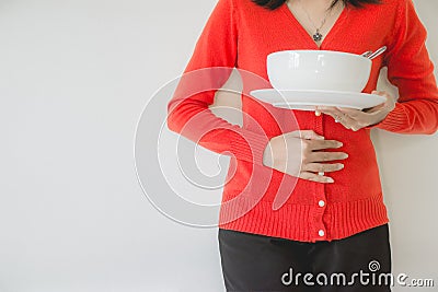 Digestion problems,Woman with stomach pain after eating,Hand female holding her belly,Do not eat on time Stock Photo