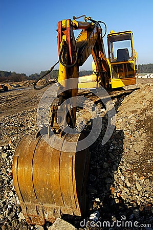 Digger dig out in industrial landscape Stock Photo