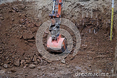 Digger digging out dirt Stock Photo