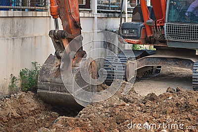 Digging a trench excavator. Excavation work in the summer. Stock Photo