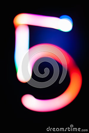 Digit 5. Five. Glowing numbers on dark background. Abstract light painting at night. Creative artistic colorful bokeh. New Year. Stock Photo