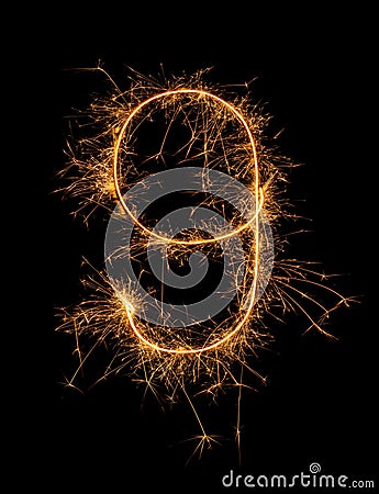 Digit 9 or nine made of bengal fire, sparkler fireworks candle isolated on a black background Stock Photo