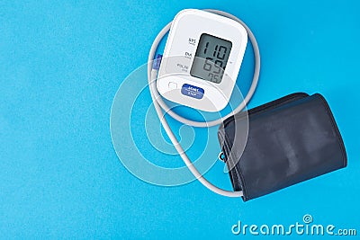 Digital blood pressure monitor on a blue background, closeup. Helathcare and medical concept Stock Photo