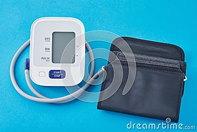 Digital blood pressure monitor on a blue background, closeup. Helathcare and medical concept Stock Photo