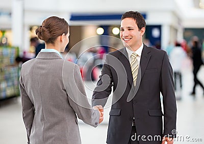 business woman and man handshake. shopping centre Stock Photo