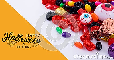 Digital composite of happy halloween text over spooky candy sweets on white table Stock Photo