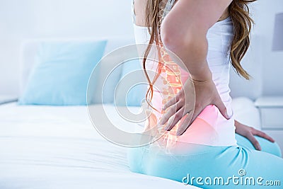 Digital composite of highlighted spine of woman with back pain Stock Photo