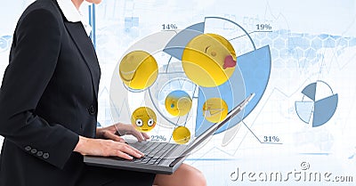 Digital composite image of emojis flying by businesswoman using laptop against tech graphics in back Stock Photo