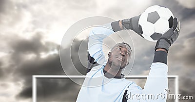 Soccer goalkeeper saving football in goal Stock Photo