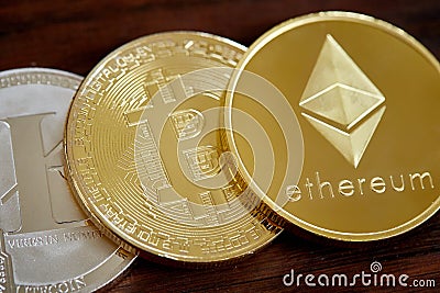 Digital cryptocurrencys Bitcoin, Ethereum, Litecoin on wooden background. Cryptocurrency concept, close-up Editorial Stock Photo